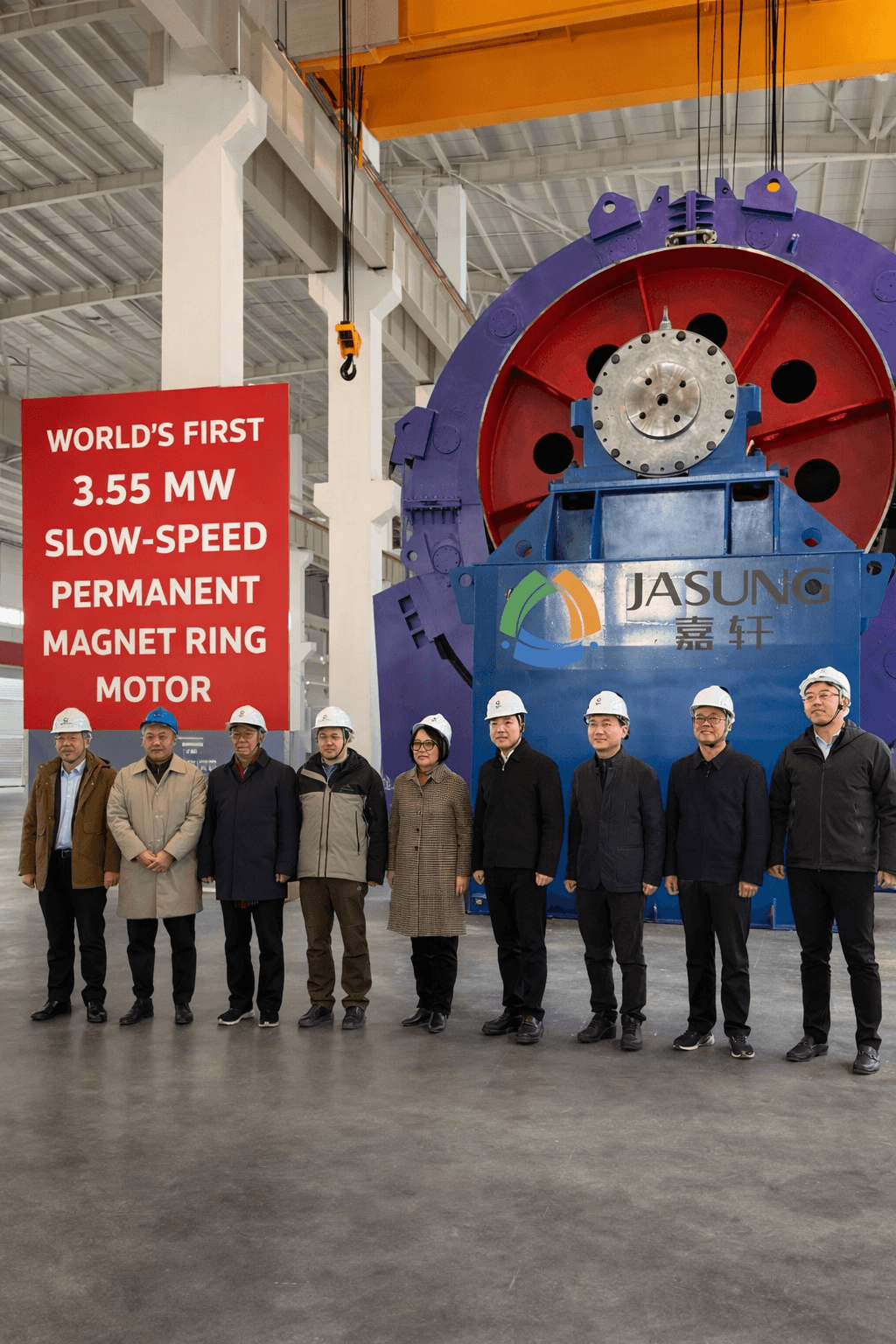 Group in hard hats standing before a massive 3.55 MW permanent magnet ring motor.