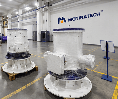 Two large white industrial components wrapped in plastic sit on pallets in a Motiratech factory.